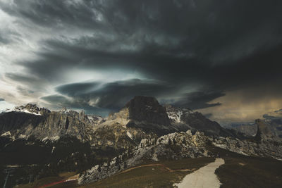Scenic view of mountains against storm cloudy sky