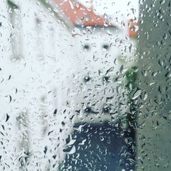 Full frame shot of wet glass window in rainy season