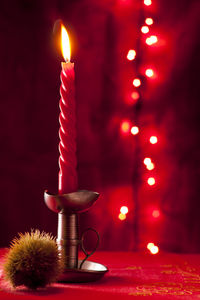 Close-up of illuminated candles on table