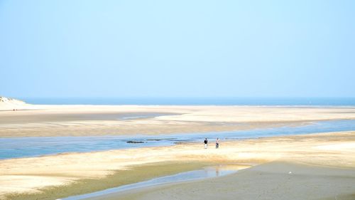 Scenic view of beach against clear sky