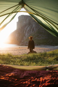 Rear view of man standing on field
