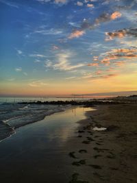 Scenic view of beach against sky during sunset
