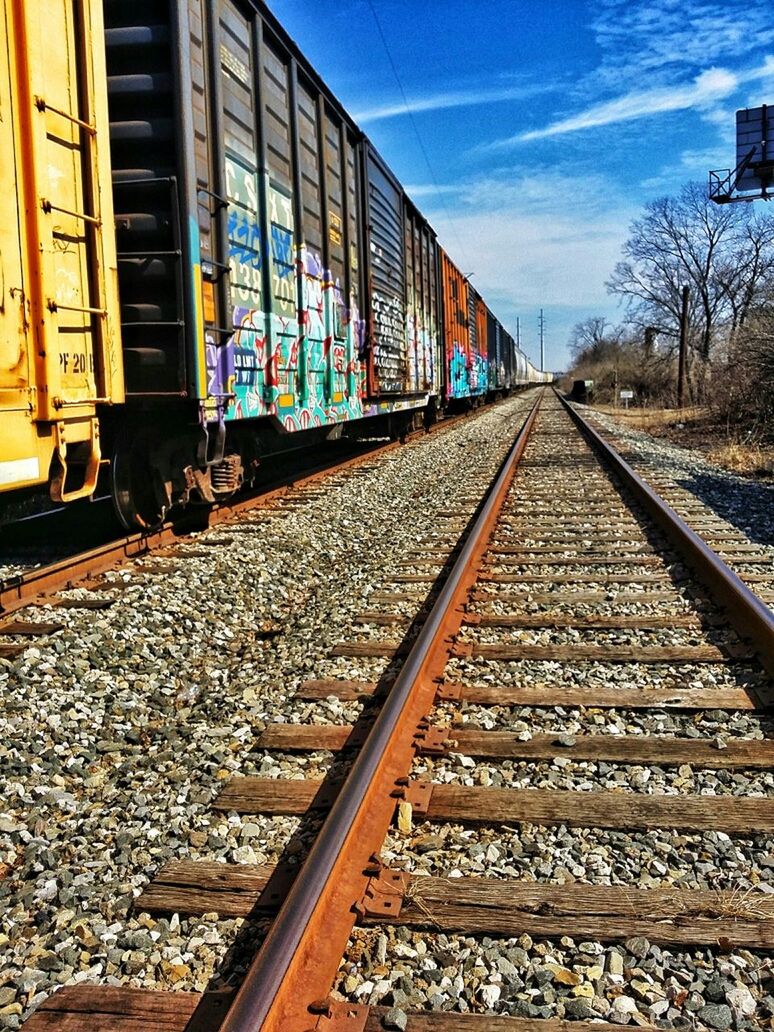 railroad track, rail transportation, transportation, public transportation, the way forward, diminishing perspective, railroad station platform, railroad station, vanishing point, railway track, built structure, architecture, building exterior, surface level, tree, day, sky, blue, no people, travel