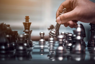 Close-up of hand playing chess