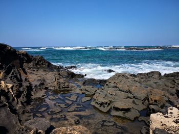 Scenic view of beach against clear sky