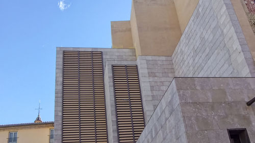 Low angle view of buildings against clear blue sky