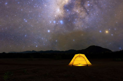 Scenic view of mountains against sky at night