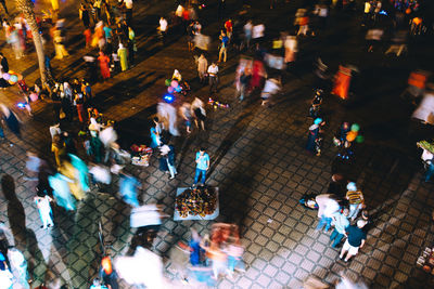 High angle view of people walking on street in city
