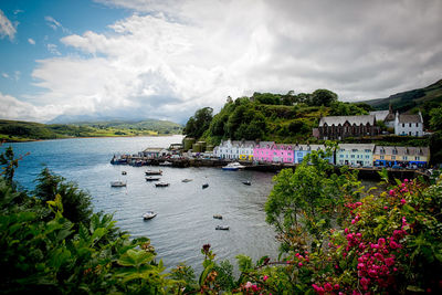 Scenic view of portree with harbor against cloudy sky