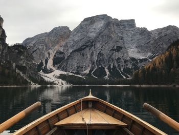 Boat in river against majestic mountains