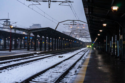 Illuminated railroad station platform during winter