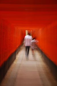 Rear view of woman walking in corridor