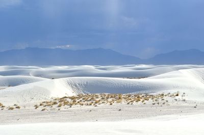 Scenic view of snow covered landscape against cloudy sky