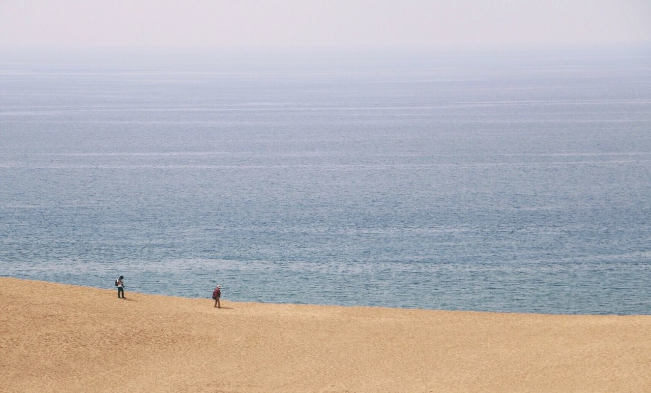 water, beach, sea, vacations, tranquility, tranquil scene, high angle view, scenics, ocean, shore, seascape, sand, calm, idyllic, beauty in nature, tourism, summer, tourist, nature, solitude, remote, distant, coastline, relaxation, blue, non-urban scene, weekend activities, escapism