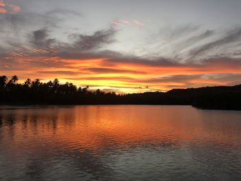 Scenic view of lake against romantic sky at sunset