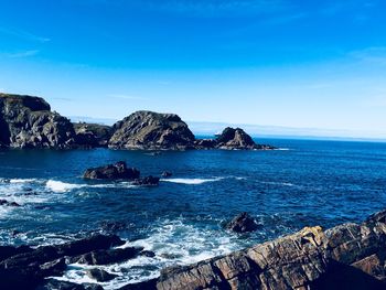 Scenic view of sea against blue sky