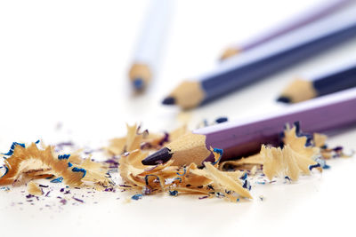 Close-up of colored pencils on white background