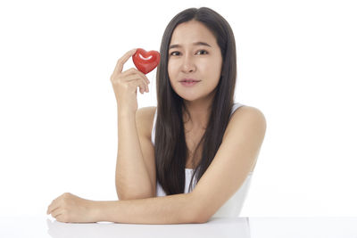 Portrait of a beautiful young woman over white background