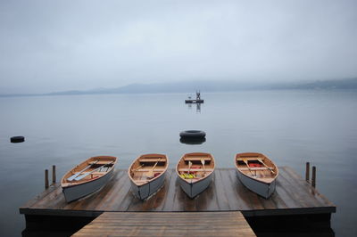 High angle view of boats moored on pier over lake