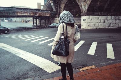 Rear view of woman walking on street