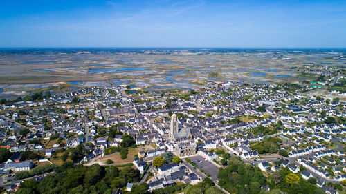 High angle view of cityscape by sea against sky