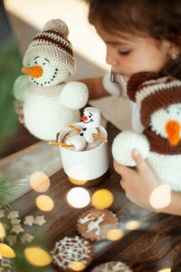 High angle view of woman with smores on table