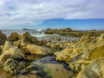 Close-up of rocks on shore against sky