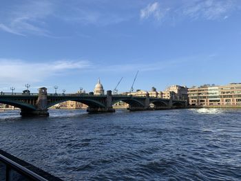 Bridge over river with city in background