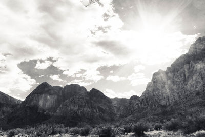 Scenic view of mountains against cloudy sky