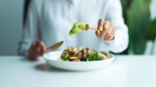 Midsection of woman having food