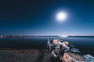 Scenic view of sea against sky at night