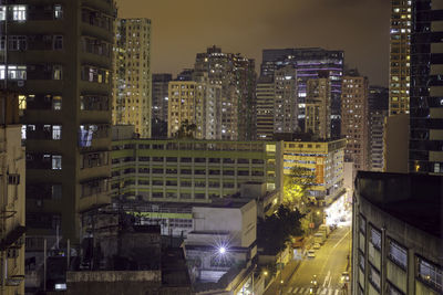 High angle view of illuminated buildings in city at night