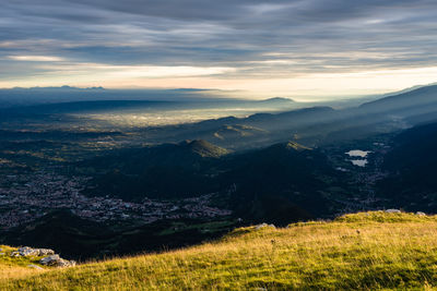 Scenic view of mountains against cloudy sky