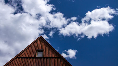 Low angle view of building against cloudy sky