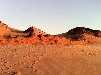 Sand dune against clear sky