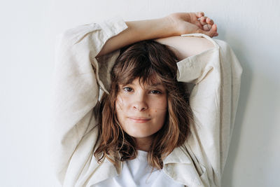 Portrait of young woman lying on bed at home