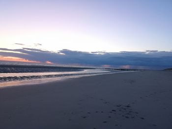 Scenic view of beach against sky during sunset