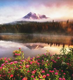 Scenic view of lake by mountain against sky