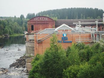 Building by river against sky