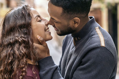 Side view of couple embracing outdoors