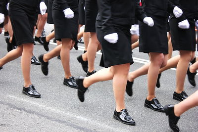 Low section of people walking on street