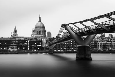 Low angle view of bridge over river in city