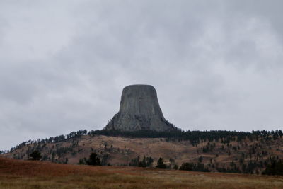 Rock formations on field against sky