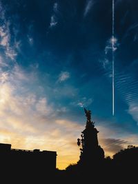 Low angle view of silhouette statue against sky during sunset