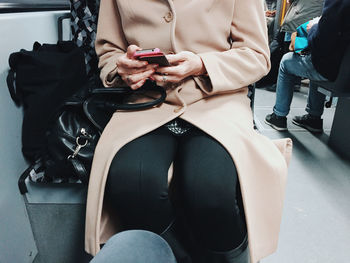 Close-up of woman sitting on table