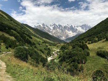 Scenic view of mountains against cloudy sky