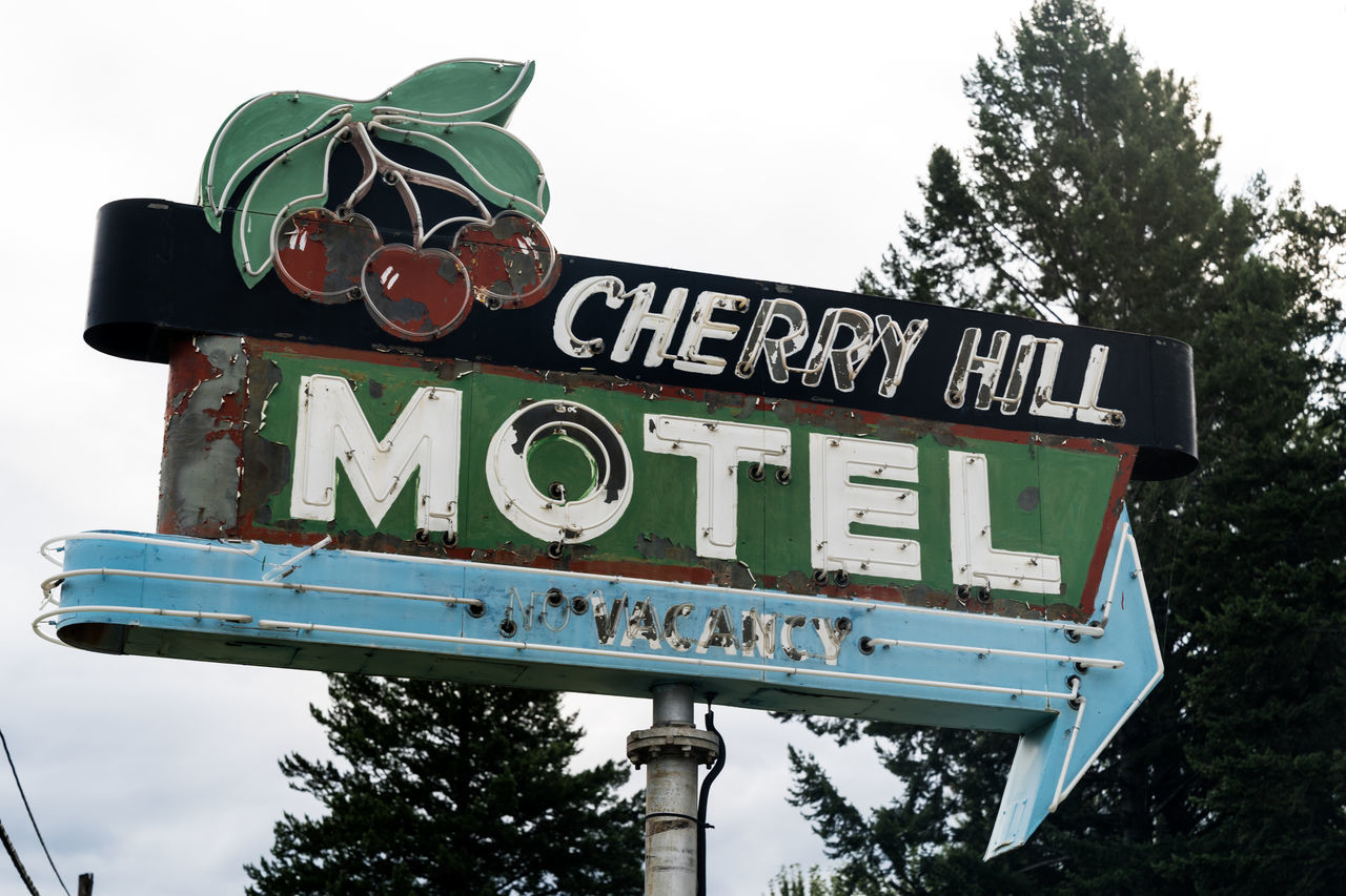 LOW ANGLE VIEW OF SIGN AGAINST SKY