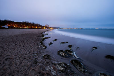 Scenic view of beach against sky during winter