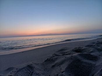 Scenic view of beach against sky during sunset