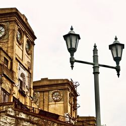 Low angle view of street light against building